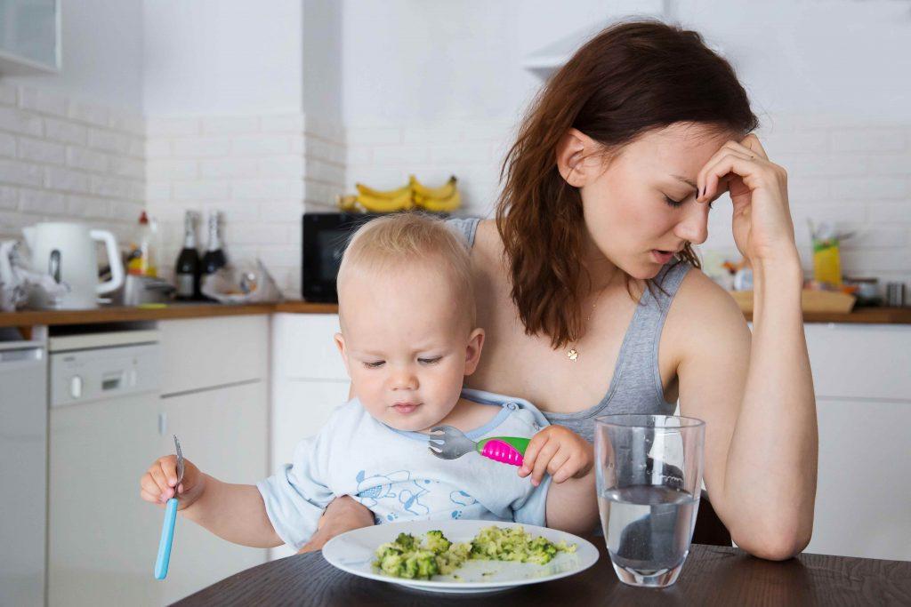 Frustrated Mom Feeding Baby