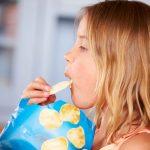 Girl-Snacking-on-Chips. How Snacking is contributing to our Nation’s Obesity Epidemic