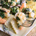 Ravioli With Seafood, Spinach And Mushrooms In Garlic Cream Sauce