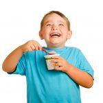 happy boy eating yogurt