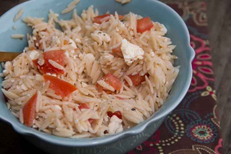 This easy orzo salad combines salty feta cheese with fresh cherry tomatoes. Super easy and goes great with a ton of meals!